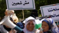 Palestinian women take part in a protest calling for an end to political division outside the Palestinian Legislative Council in Gaza City on 26 April 2016. (Photo by Majdi Fathi/NurPhoto via Getty Images)