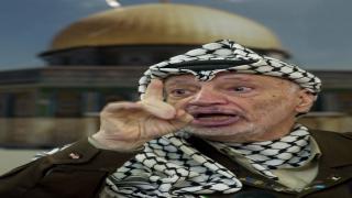 FILE - In this Dec. 24, 2002 file photo, Palestinian leader Yasser Arafat talks to the media during a press conference at his headquarters, in the West Bank town of Ramallah. Yasser Arafat's body may be exhumed to allow for more testing of the causes of his death, the Palestinian president said Wednesday, July 4, 2012, after a Swiss lab said it found elevated levels of a radioactive isotope in belongings the Palestinian leader is said to have used in his final days. (AP Photo/Muhammed Muheisen, File)